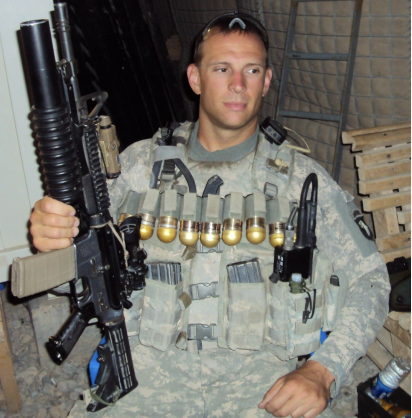 US Army E-5 member Shane Tate posed with guns in camo and military gear during active service 