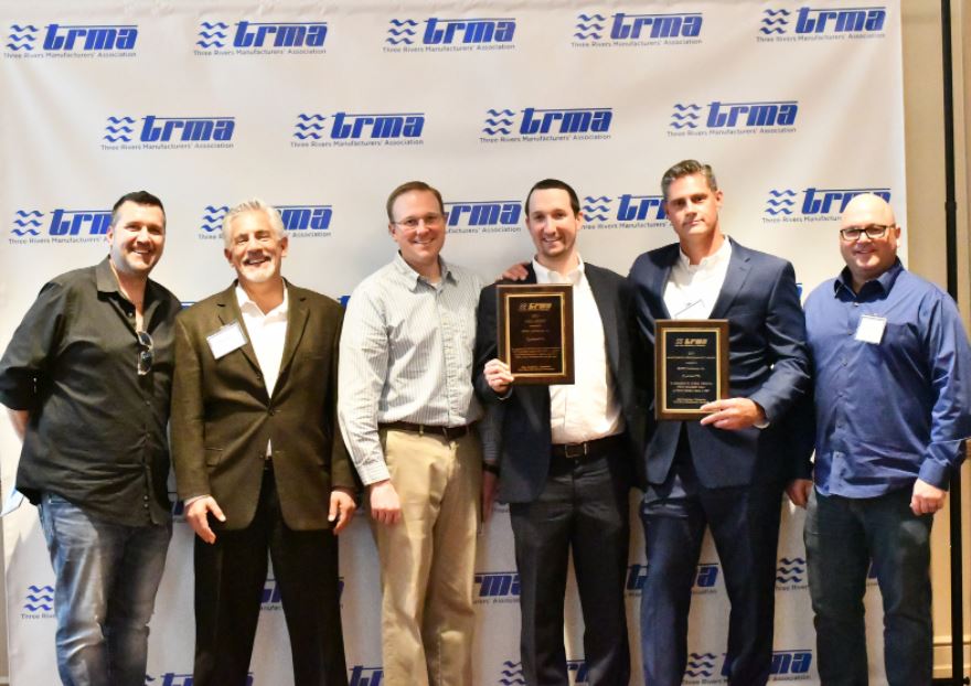 Three Rivers Manufacturers’ Association (TRMA)  Award Winner BMWC standing with trophies 